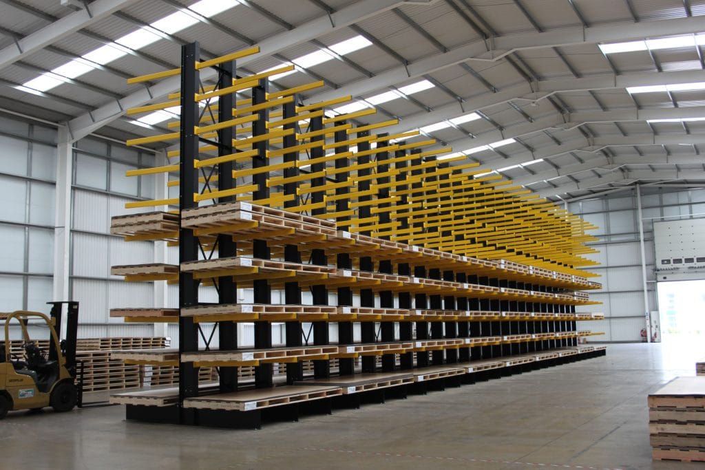 Cantilever racking with yellow arms storing long stock